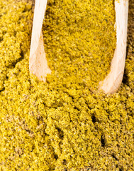 scoop on pile of spice mix khmeli suneli closeup