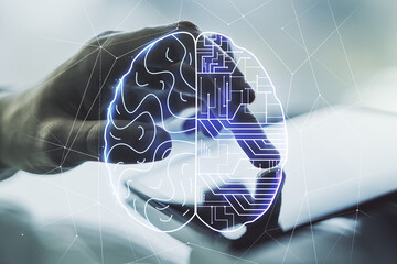 Double exposure of creative human brain microcircuit and hand working with a digital tablet on...