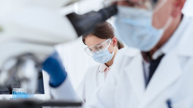 image of a group of scientists working conducting research in a medical laboratory.