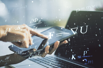 Creative scientific formula concept with finger clicks on a digital tablet on background....