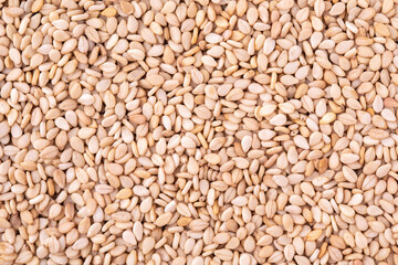 Sesame seeds on wooden background, close up, view from above
