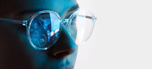 Close up view of blue eye in glasses with futuristic holographic interface to display data. Portrait of beautiful young woman, half of face. Augmented reality, future technology, internet concept. - obrazy, fototapety, plakaty