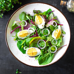 egg salad vegetables fresh green leaves mix spinach, arugula, lettuce, eggs boiled organic food healthy meal snack copy space food background top view veggie vegetarian keto or paleo diet