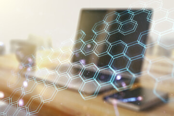 Creative concept of wireless technology with hexagon hologram and modern desktop with computer on...