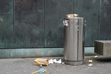 Food rubbish in and around public rubbish bin in the street. Result of take away food sold in times...