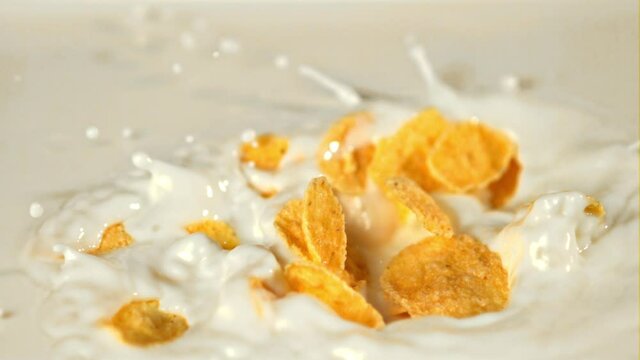 Super slow motion in the milk fall cornflakes with spray.Filmed on a high-speed camera at 1000 fps. High quality FullHD footage