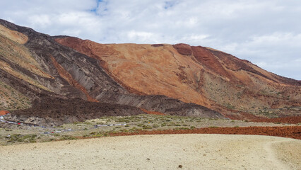 Landscape with different colorful lava of Teide in National Park Mount Teide with bushes