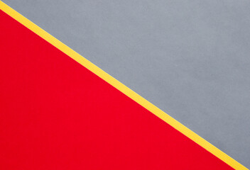 Gray and red diagonally divided with yellow stripe colored paper background