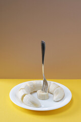 Slices banana with a fork