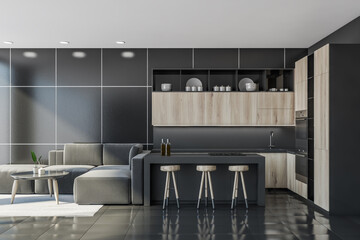 Dark kitchen interior with table and sofa on tiled floor