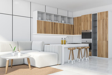 White kitchen interior with table and sofa on tiled floor