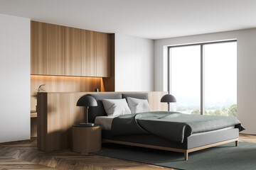 Stylish modern interior of contemporary bedroom with comfortable furniture. Bed for two with blanket and pillows. Wooden parquet floor. Big window.