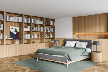 Stylish modern interior of contemporary bedroom with comfortable furniture. Bed for two with blanket and pillows, book with bookshelf. Wooden parquet floor.