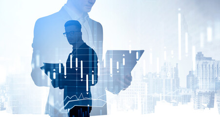 Two young business people researching financial data based on reports. Skyscrapers and stock market candlesticks dynamics, bar chart, double exposure. Concept of worldwide financial advisory