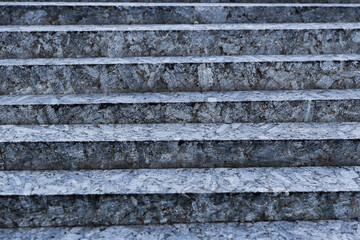 Small steps of unpolished gray stone close-up