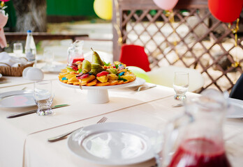 assorted fresh fruit and marmalade on a plate on the table. A healthy dessert 