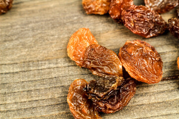 Sultana raisins on gray wooden board
