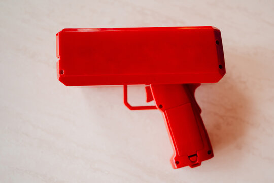 A bright red gun that shoots with money. 