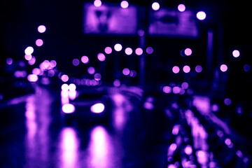 Rainy night in the big city, cars traveling on wet highway.  Defocused image