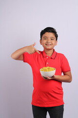 Indian kid or boy eating noodles.