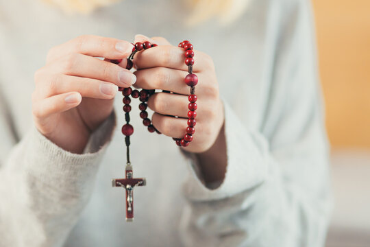 prayer hands with rosary