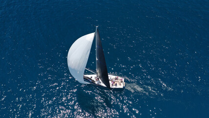 Aerial drone top down photo of beautiful sailing boat cruising in deep blue Atlantic open ocean sea