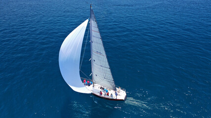 Aerial drone top down photo of beautiful sailing boat cruising in deep blue Atlantic open ocean sea