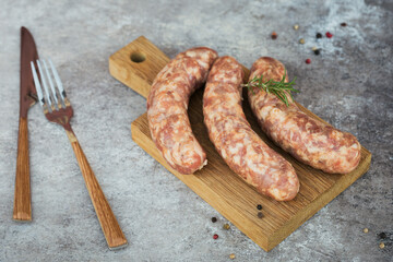 Raw homemade sausages with peppercorn and rosemary herb