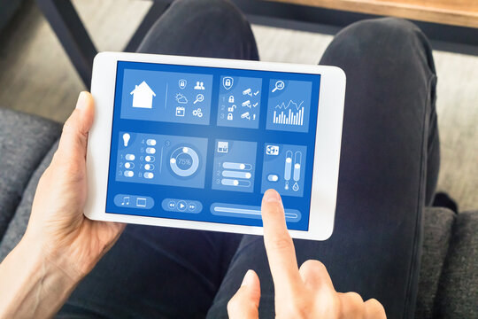 Person using smart home automation dashboard on digital tablet computer