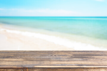 Fototapeta na wymiar wood table top on blur sea background