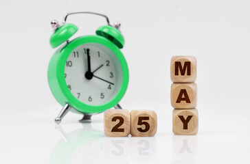 On a white background there is an alarm clock and a calendar with the inscription - MAY 25