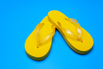 yellow flip flops on a blue background
