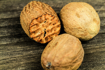 Natural and tasty Nutmegs on wooden board