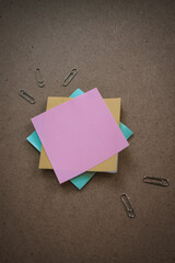 Collection of different colored sheets of note papers the stick on the wall, ready for your message
