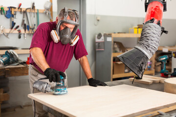 Worker grinds the wood plank of angular grinding machine. High quality photo