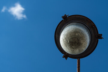 Bottom view of street lantern on blue sky background