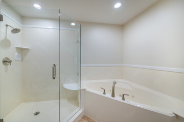 Minimalistic bathroom interior design in white color with a bathtub and a cabin