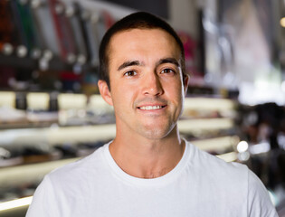 Close up portrait of smiling male shopper in modern clothes store