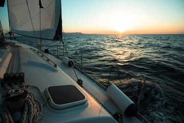 Fototapeta premium Yacht boat in the open Sea during amazing sunset. Luxury Sailing.