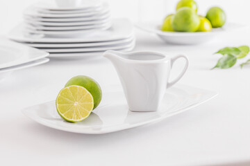 Minimalist white porcelain composition with lemons and avocado