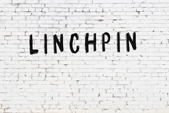 White wall with black paint inscription linchpin on it