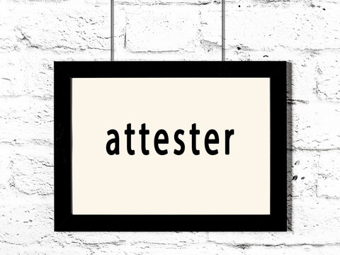Black frame hanging on white brick wall with inscription attester