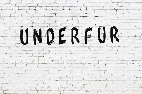 White wall with black paint inscription underfur on it