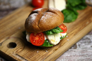 Mozzarella sandwich. A healthy sandwich with mozzarella, tomato and spinach. Caprese sandwich. A healthy snack.