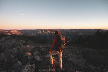Fototapeta premium person standing on a cliff