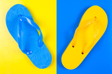 blue and yellow rubber slippers on blue and yellow background