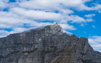 Scenic view of Table mountain top cable way station with white fluffy clouds - Great outdoors adventure and travel holiday destination, Cape Town, South Africa