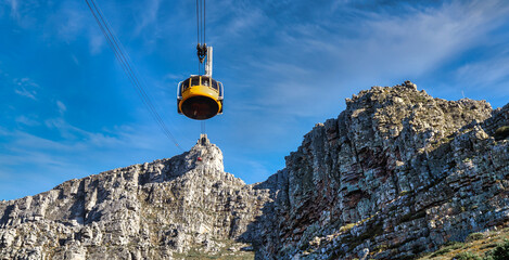 Table mountain yellow cable car with a view towards the top cable way station - Great outdoors adventure and travel holiday destination, Cape Town, South Africa
