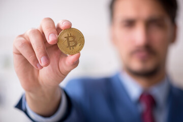 Young man earning money via Internet in cryptocurrency concept