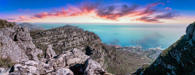 Table mountain from the top, looking out towards the Southern coastline with enhanced sunset sky - Great outdoors adventure travel destination, Cape Town, South Africa